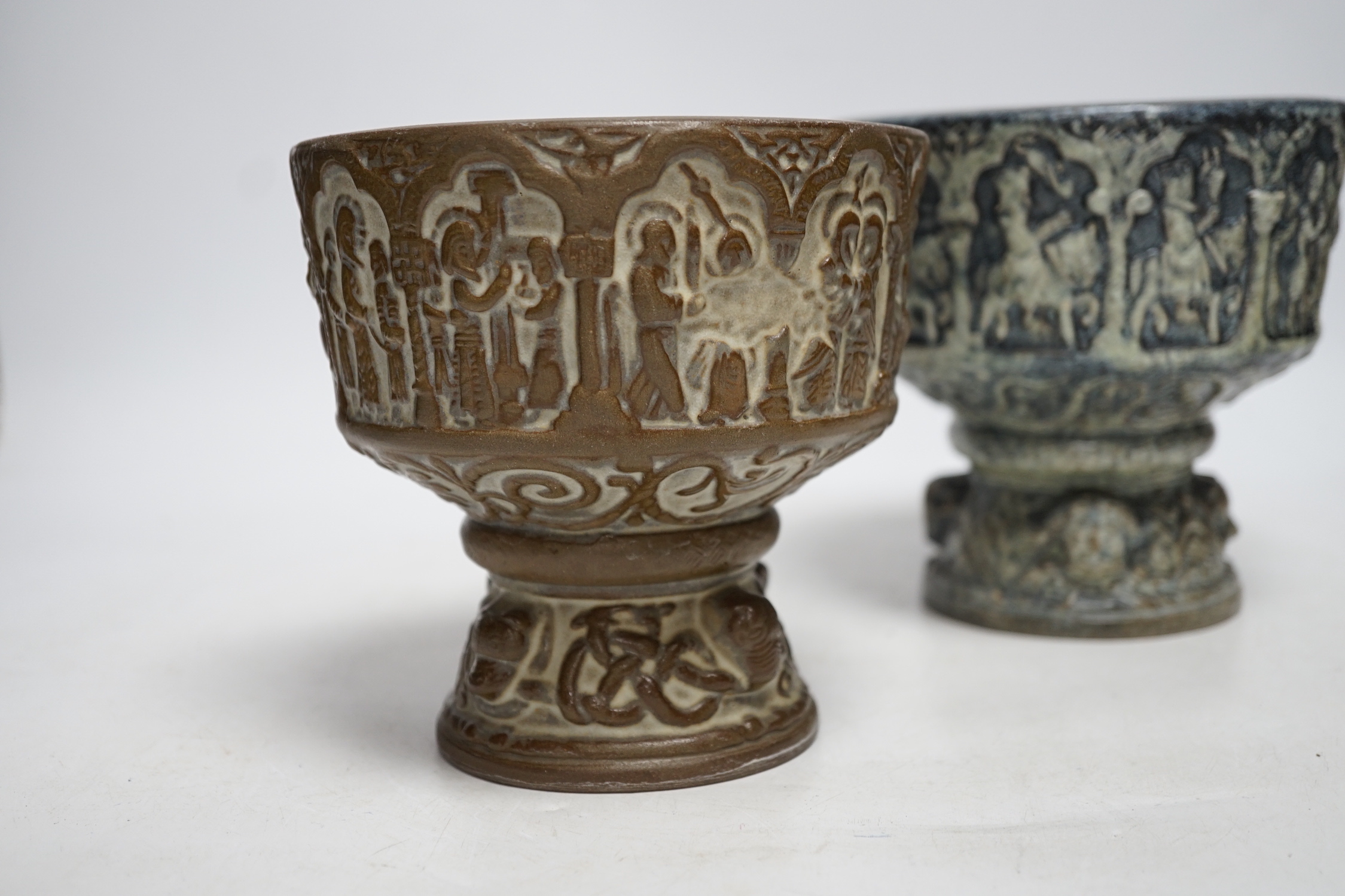 Two Michael Andersen & Sons, Denmark miniature stoneware fonts, one with label to the base; MA&S, both with the same impressed design of the life of Christ, tallest 14.5cm